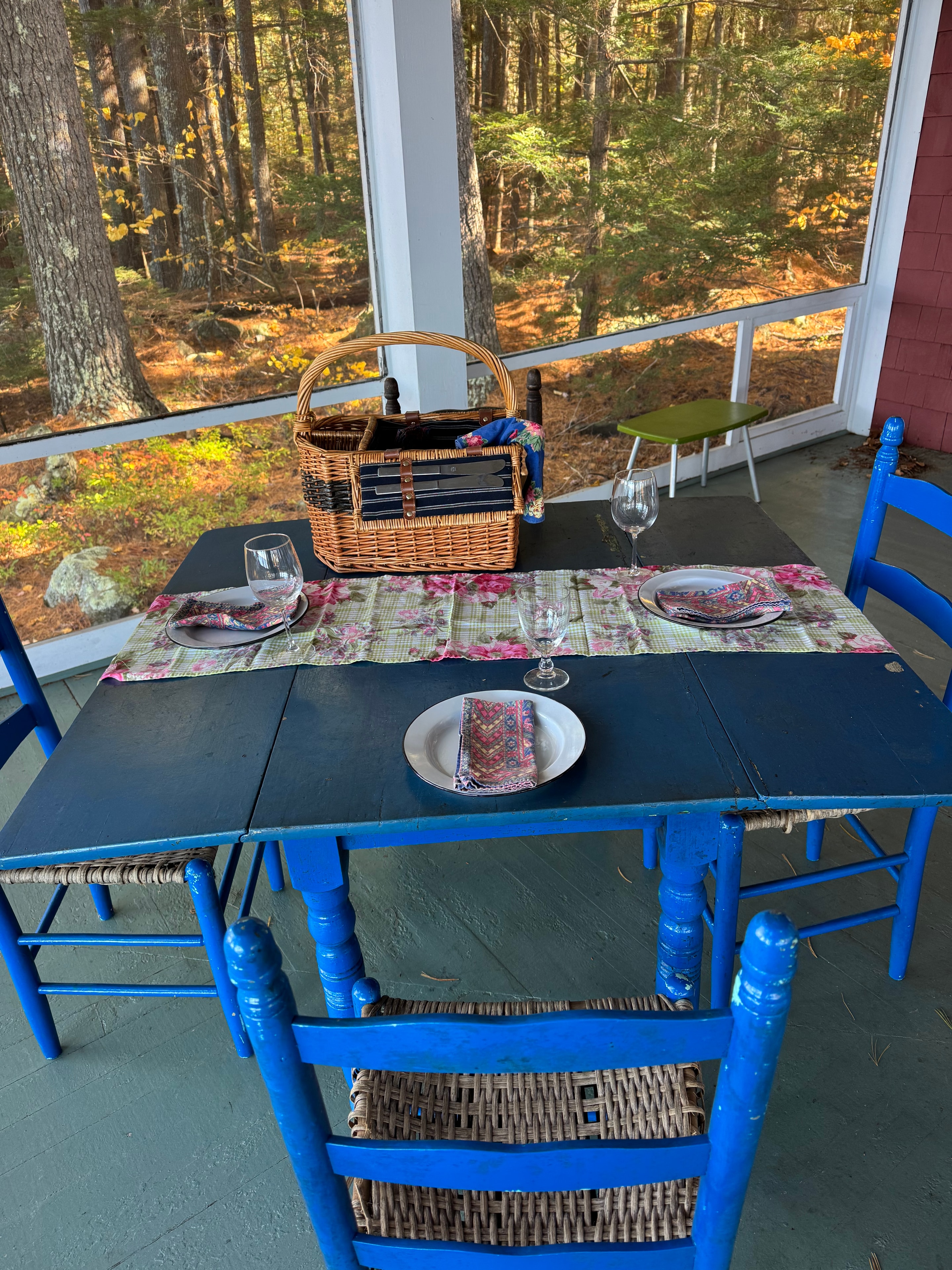 Lake camp porch after staging — staged outdoor dining table